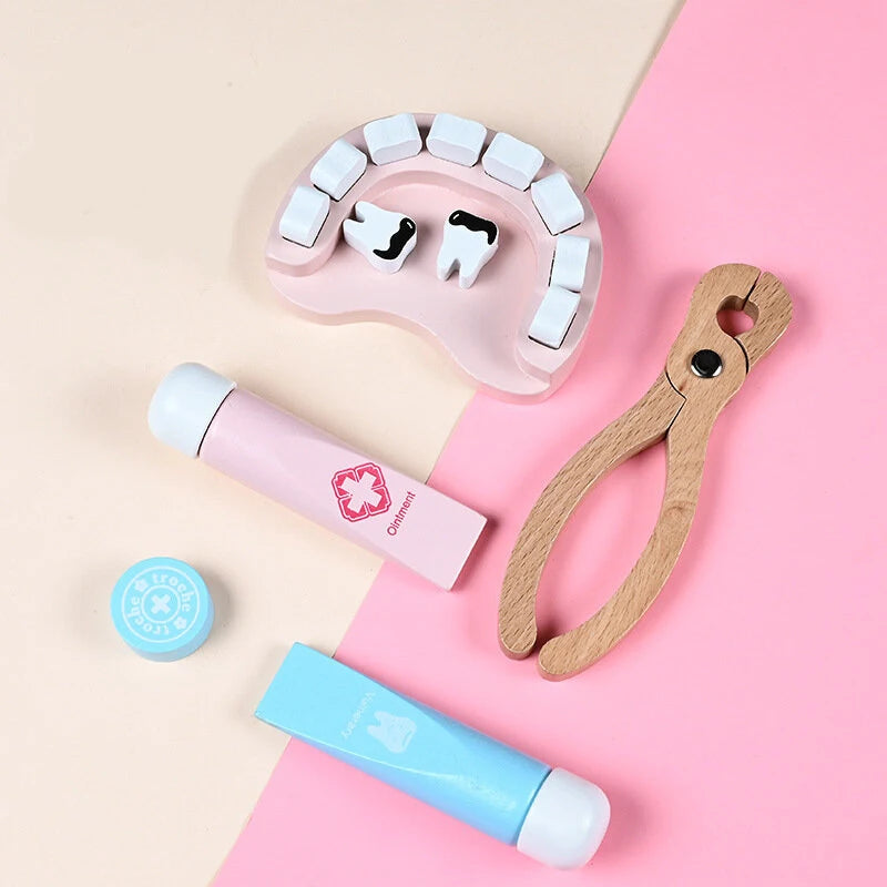 Accesorii de dentist Lean Toys cu model dentar, clește din lemn, pastă și instrumente medicale.