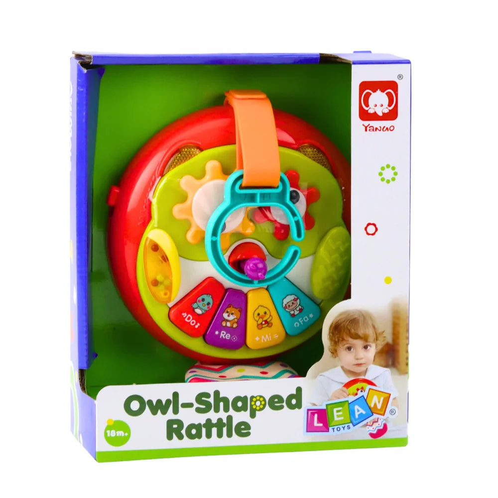 Ambalaj pentru bufnița interactivă Owl-Shaped Rattle, cu produsul vizibil în cutie.