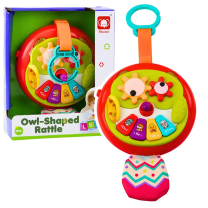 Bufniță zornăitoare Lean Toys prezentată lângă ambalaj, cu pianină și coadă textilă.