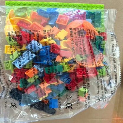 Piese colorate Woopie Crazy Marble Run în punga originală, cu bază verde și marcaje de siguranță.