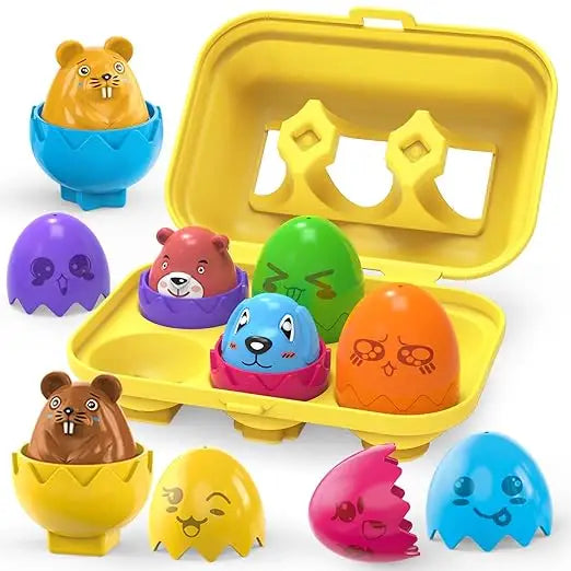 Set complet Woopie Ouă cu animale în cutie galbenă, cu ouă colorate și figurine surpriză.