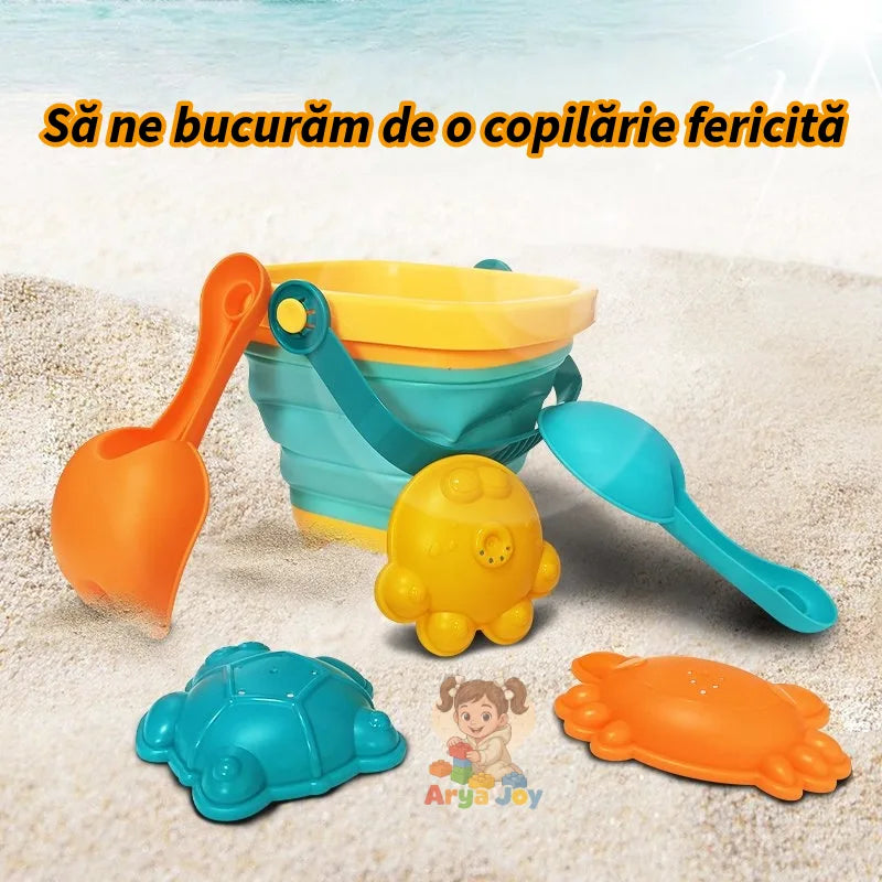 Set de plajă Woopie Baby cu găletușă pliabilă, lopățică, greblă și forme colorate pe nisip.